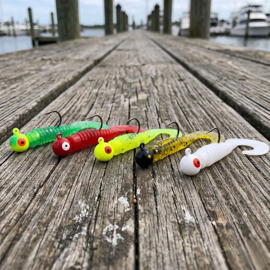 Norte 5-color finesse jig and grub set displayed on a wooden dock with fishing boats in the background