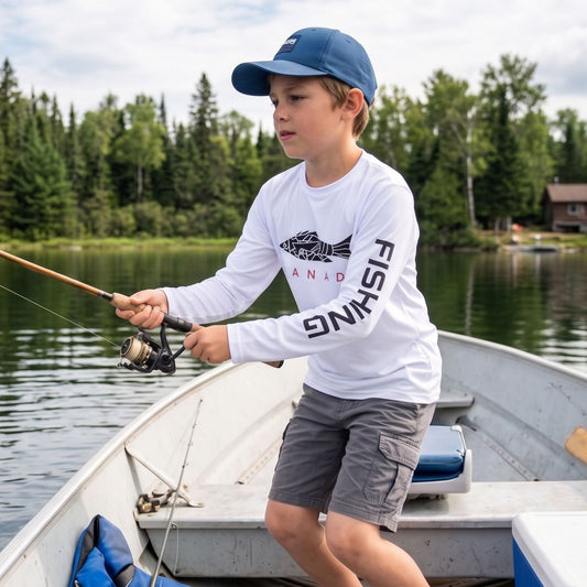 Norte Youth Technical Rash Guard worn by a child fishing from a boat on a Canadian lake, featuring white UPF 50+ fabric and signature sleeve branding.