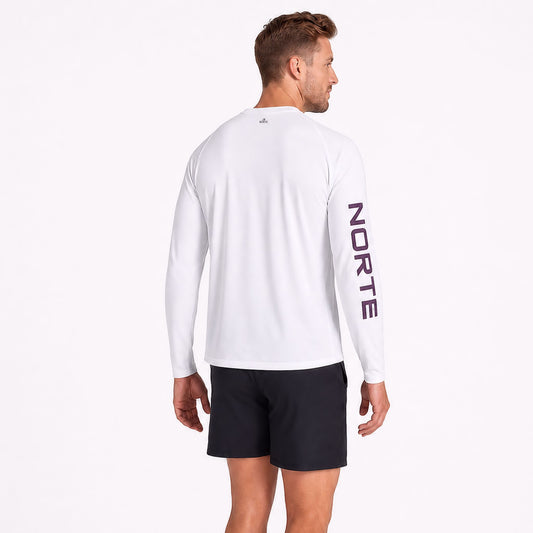 Back view of an athletic man wearing a Norte brand white long sleeve performance shirt showcasing the bold vertical NORTE sleeve branding on the left arm
