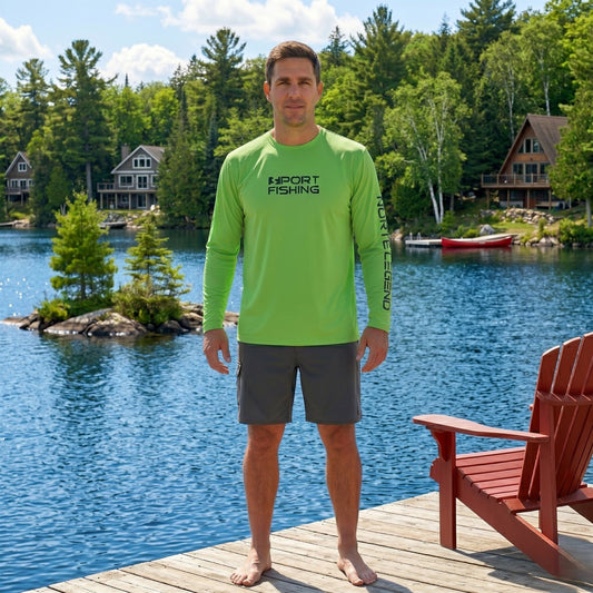 Male angler wearing the Norte Legend Performance Fishing Shirt in Electric Lime, standing on a summer cottage dock with a lake and forest background.