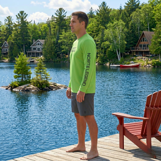 Side view of the Norte Legend Fishing Shirt showcasing the "Norte Legend" sleeve graphic and relaxed performance fit on a summer dock.