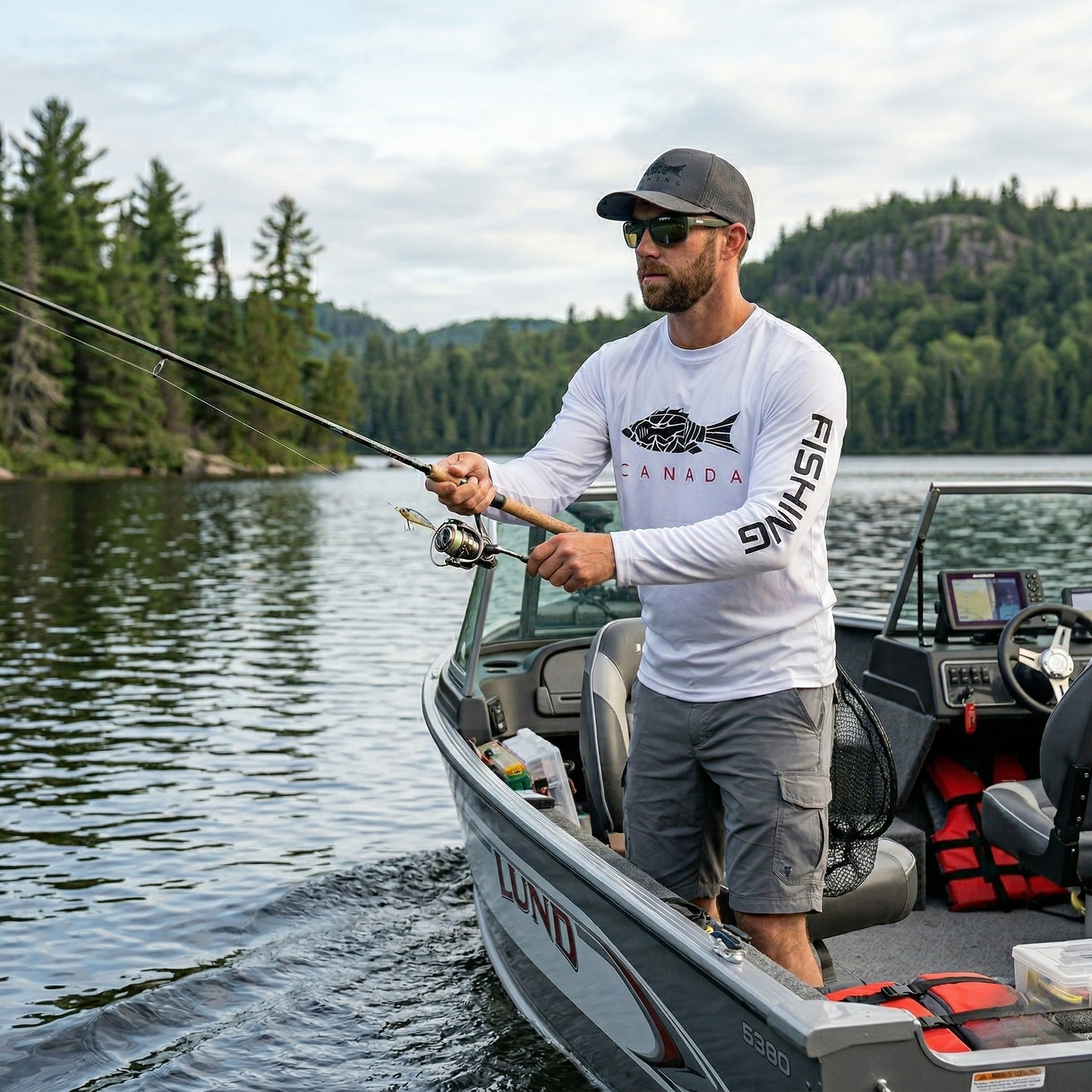 Angler fishing from a boat wearing the Norte Canada rash guard, showcasing high-intensity movement and moisture-wicking performance.