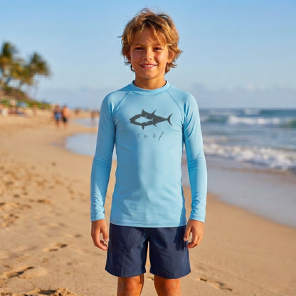 Youth long sleeve performance rash guard in Sky Blue with tuna fish graphic and surf script, featuring UPF sun protection and moisture-wicking fabric for kids fishing and beach days.